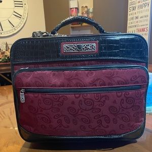 Vintage Brighton Rolling Briefcase. There is one area that is torn